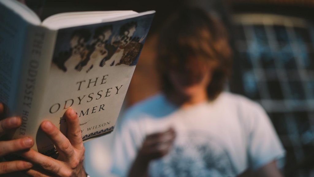 A reader engrossed in the pages of The Odyssey.